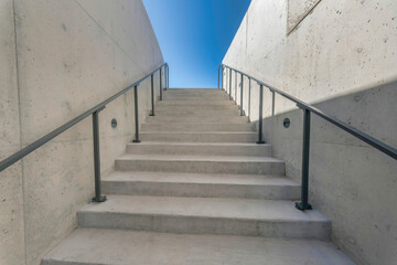 Austin, Texas- Concrete stairs with floor-mounted handrails