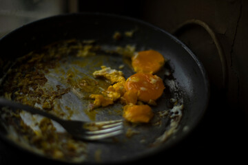 Scrambled eggs on frying pan. Egg yolk. Poor breakfast. Natural food.