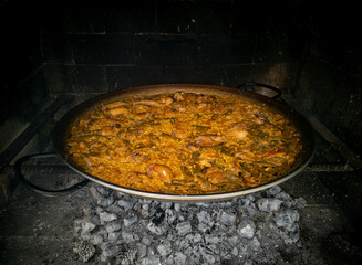 Spanish typical paella on fire, closeup view