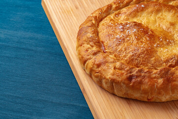 Apple pie on a wooden board close up