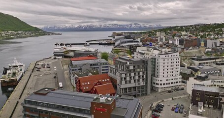 Tromsø Norway Aerial v19 cinematic low level flyover waterfront attractions along the shore at tromsøya island capturing mountainscape across tromsøysundet strait - Shot with Mavic 3 Cine - June 2022