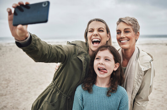 Beach, grandma and child selfie with phone for happy family holiday break together in Canada. Mother, daughter and grandmother capture joyful picture for social media on ocean leisure walk.