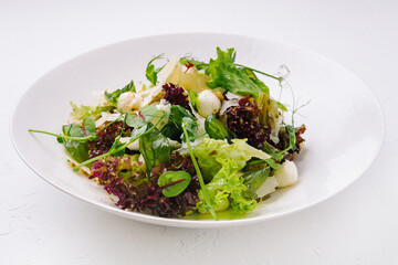 Healthy mozzarella salad on white plate