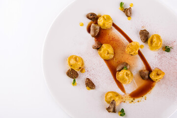 A plate of ravioli with fried kidneys and paprika