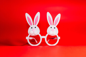 Two Toy Rabbit Bunny symbol of new year 2023 on red background.Christmas or New Year concept.Copy...