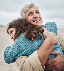 Family, children and hug with a girl and grandfather embracing on the beach outdoor during a...