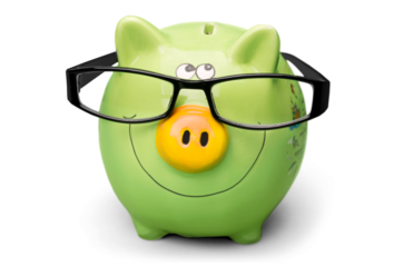 Green piggy bank in glasses on background