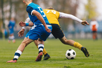 Football Players Compete in Tournament Match in a Duel. Football Game on Summer Sunny Day. Adul...