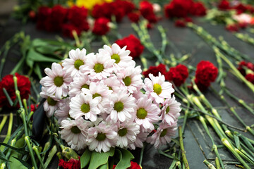 Flowers on memorial. Bouquet of flowers on gravestone.