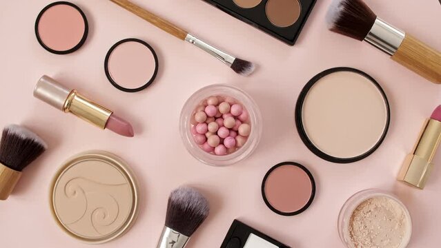 A set of decorative cosmetics on pink background. Makeup products. The beauty of the background with cosmetic facilities. Makeup, the concept of skin care with. High quality 4k footage. 4k