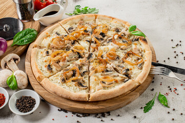 Tasty pizza with ham, mushrooms and onion on the concrete background