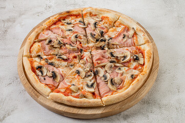 Tasty pizza with ham, mushrooms and onion on the concrete background
