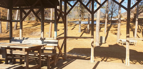 Wooden gazebo in Cavalese against the backdrop of a forest landscape. Panorama of an unusual view from the gazebo.