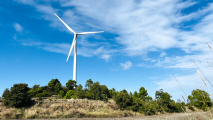Wind turbines with the sky in the background in the agriculture fields in Lerida in Spain