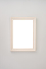 Beige empty photo frame hanging on the wall. High quality photo