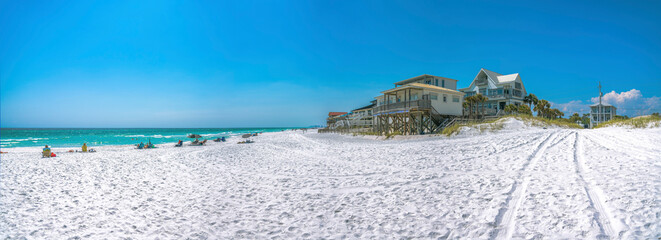 Beach houses with people at the front near the water on a beach at Destin, Florida