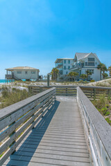 Fototapeta na wymiar Destin, Florida beach- View of beach houses from a wooden boardwalk