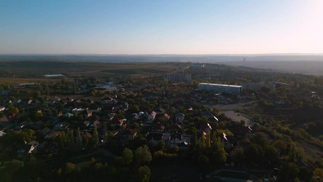 Aerial drone flyover the outer districts of the capital Chisinau of Republic of Moldova - bird view of living sleeping quarters with family homes on an autumn day in 2022 flying south of the city