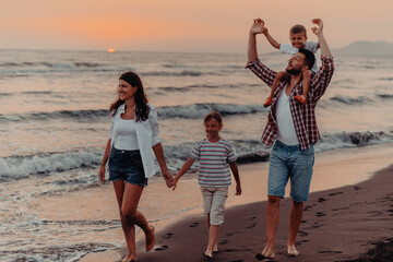 Family gatherings and socializing on the beach at sunset. The family walks along the sandy beach. Selective focus 