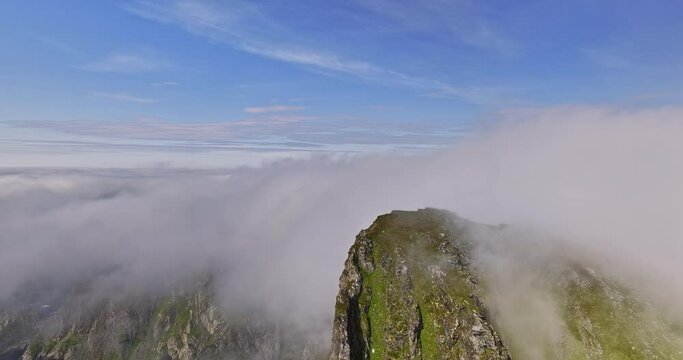 Stave Norway Aerial v19 high altitude drone fly around m&aring;tind viewpoint capturing dramatic rocky mountain peak and coastal mountainscape with thick layer of fogs - Shot with Mavic 3 Cine - June 2022