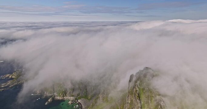 Stave Norway v18 cinematic pristine landscape view, drone fly around m&aring;tind summit viewpoint capturing craggy mountain ridges covered in thick layer of white fog - Shot with Mavic 3 Cine - June 2022