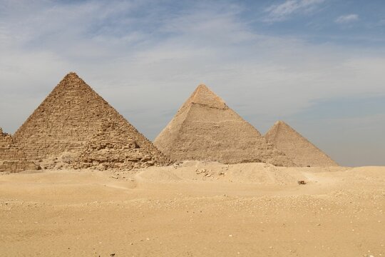 Fototapeta Famous Egyptian pyramids with their majesty in a deserted place under a cloudy sky