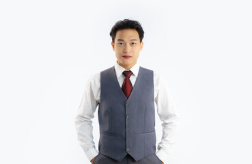 Asian handsome businessman in grey vest suit white shirt red tie looking camera white background.
