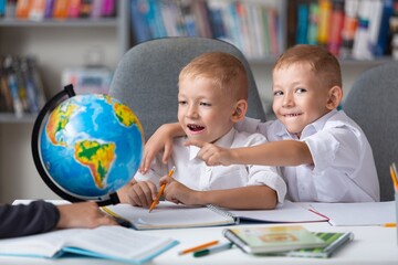 Teacher and children with globe, interesting geography learning.