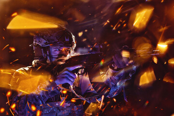Army soldier in Combat Uniforms with an assault rifle and combat helmet night mission dark...