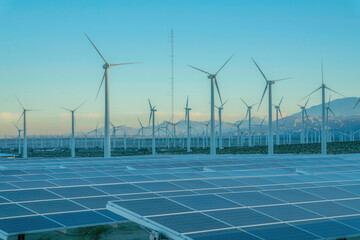Desert wind farm with solar panels and wind turbines in California © Jason