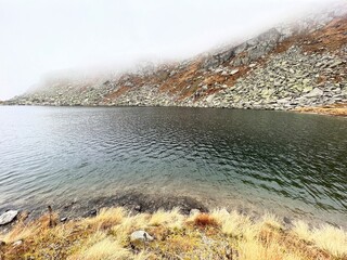 Mystical autumn ambience on the alpine lake Lago d'Orsino in the mountainous area of the St. Gotthard Pass (Gotthardpass), Airolo - Canton of Ticino (Tessin), Switzerland (Schweiz)