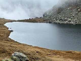 Mystical autumn ambience on the alpine lake Lago d'Orsino in the mountainous area of the St....