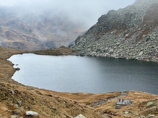 Mystical autumn ambience on the alpine lake Lago d'Orsino in the mountainous area of the St....
