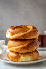 Turkish bagel pogaca with nigella seeds. Traditional flavors. Pogaca on gray background. close up