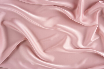 Pink silk background. Wavy folds pink silk texture satin material. Texture of the fabric. Pink...