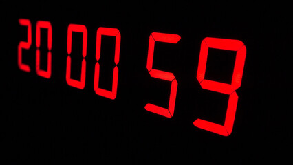 Digital timer on a black background. Light panel with red numbers