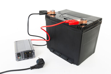 Power inverter connected to a car battery, 12v DC to AC converter 220v, on isolated white