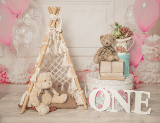 pink and white decoration for a 1st birthday cake smash studio photo shoot with balloons, paper decor, cake and topper