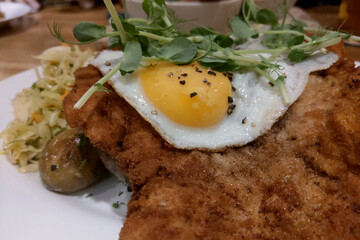 Delicious food from a fried egg and a piece of meat.