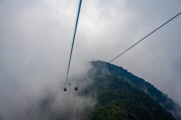Low angle shot of cable cars in the clouds in Chandragiri hills, Kathmandu, Nepal