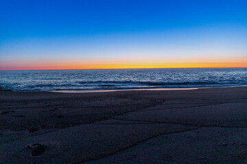 Blue hour after sunset on the beach and sea