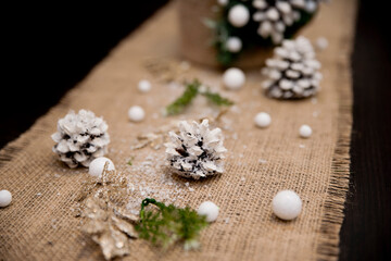 Winter Seasonal celebration. New Year festival. Hand made Christmas tree made from pine cone and spruce branches with linen background.