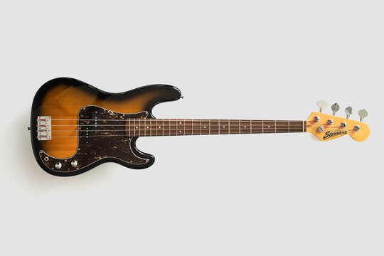 Fototapeta Old bass guitar on white background. Vintgae music wallpaper
