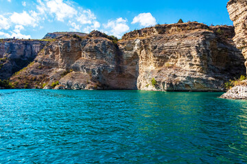 Fototapeta na wymiar Turquoise mountain lake among the rocks.