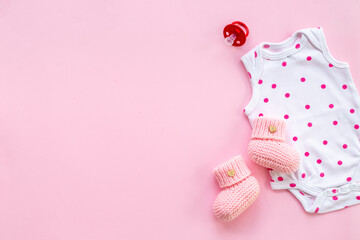 Baby cotton bodysuit with toys flat lay, top view