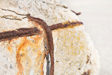 Old reinforced concrete wall without concrete cover due oxidation with damaged and rusty metallic reinforcement
