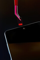 turned off smartphone and micro sd card pulled out of it with tweezers.