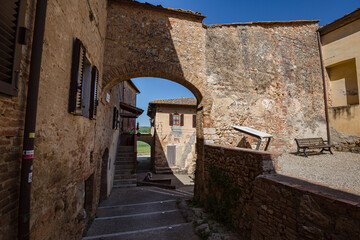 Fototapeta premium Cityscape. Medieval village in Tuscany - The Abbey of Santi Salvatore e Cirino (italian Abbadia a Isola), central Italy, near Monteriggioni, province of Siena, Italy