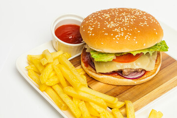 gourmet cheeseburger and french fries on wooden table  on white background.