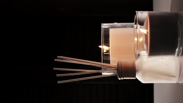 Aroma diffuser and scented candles that create coziness in the house. Romantic atmosphere. Details in the house that create coziness.